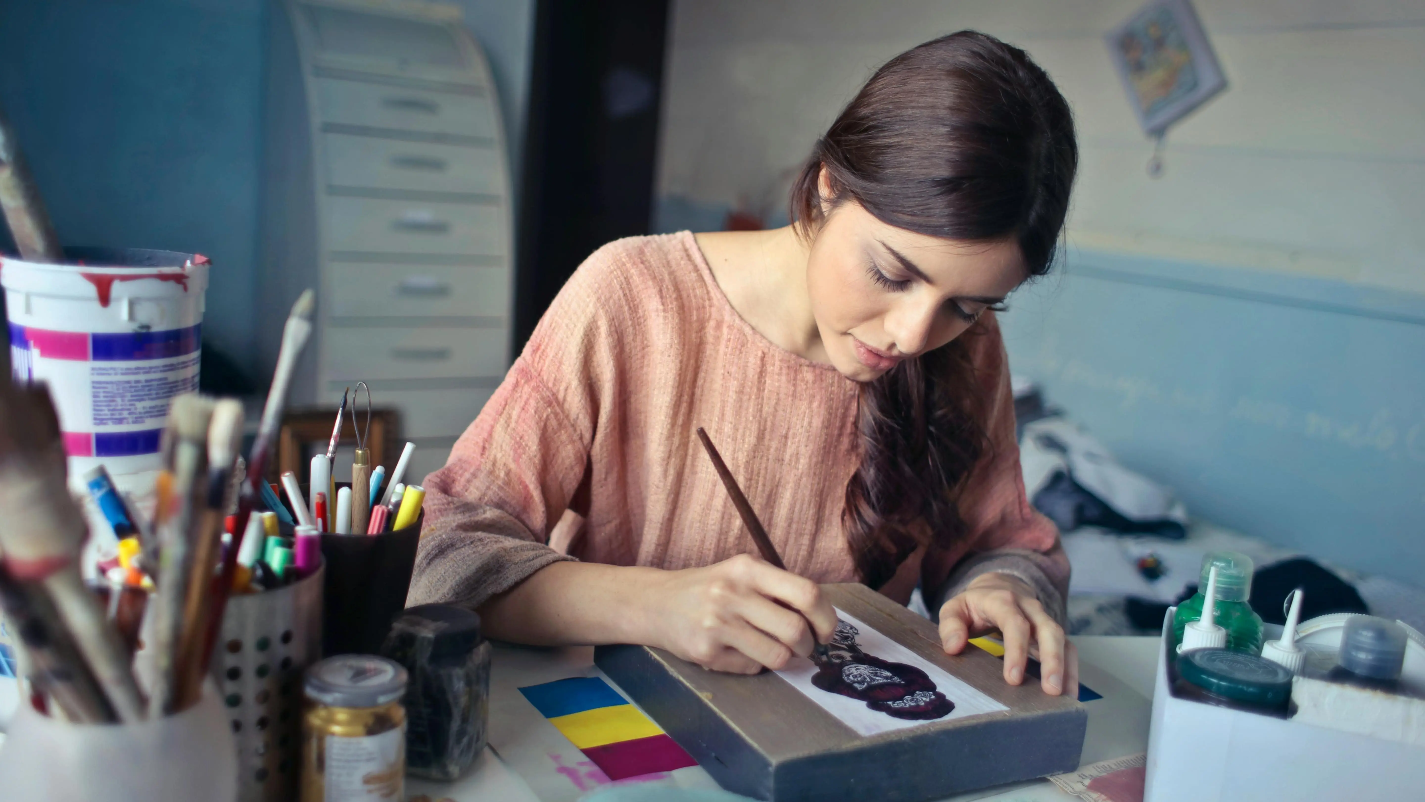 A woman painting on a canvas.