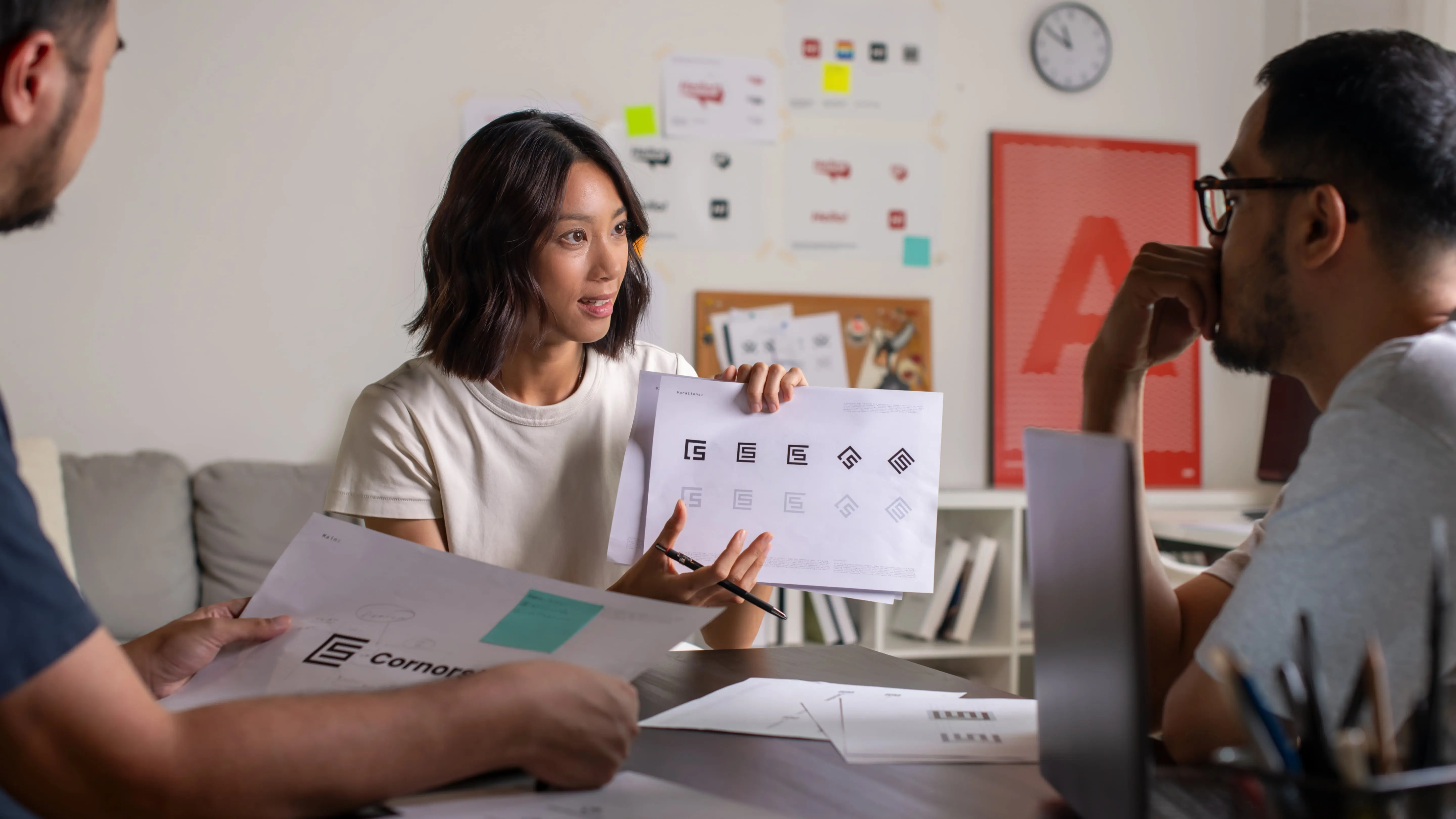 Group of Graphic designer working in office brain storming and deciding which logo they want to use.