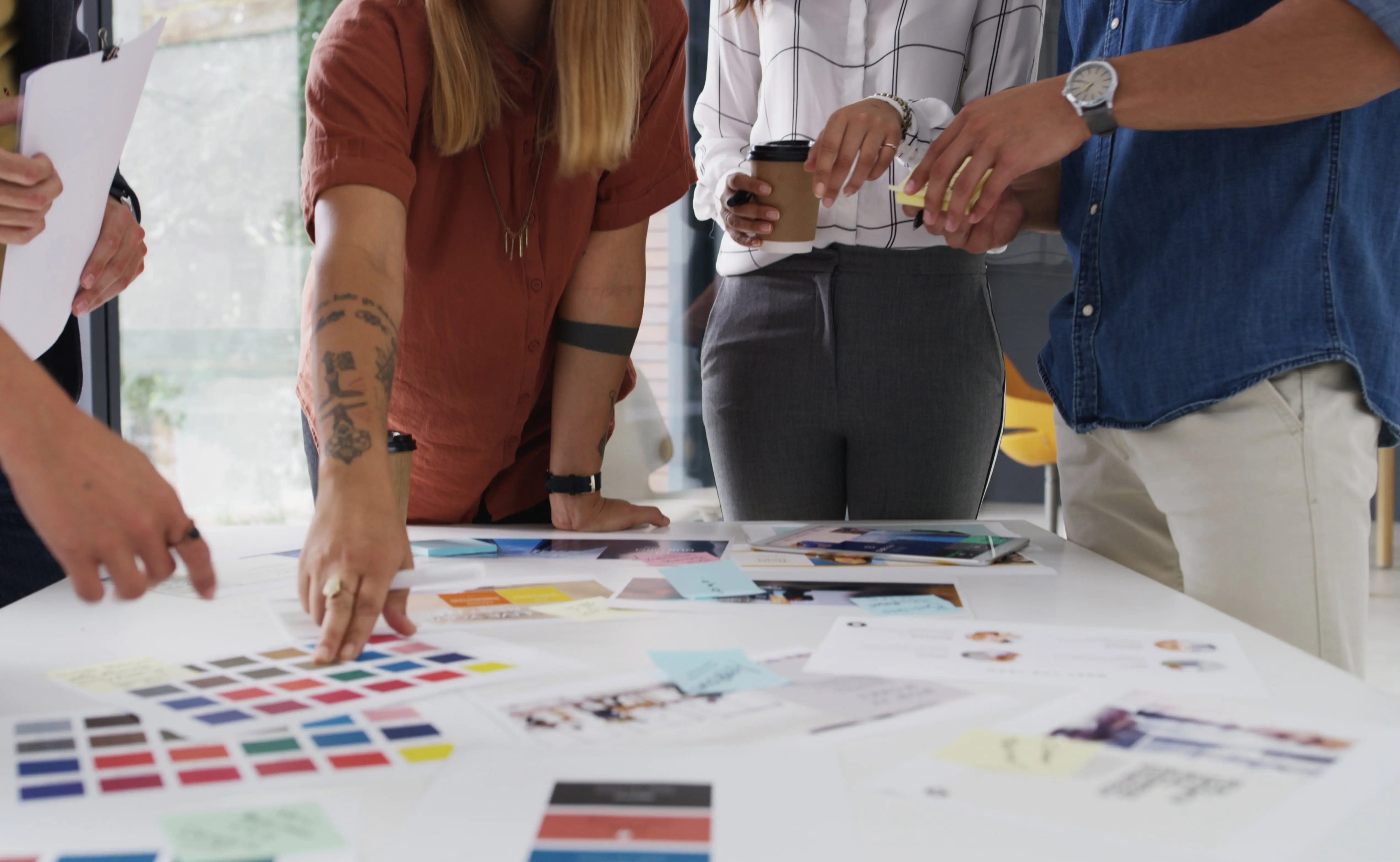 Meeting creative project manager with group of designers for company identity.