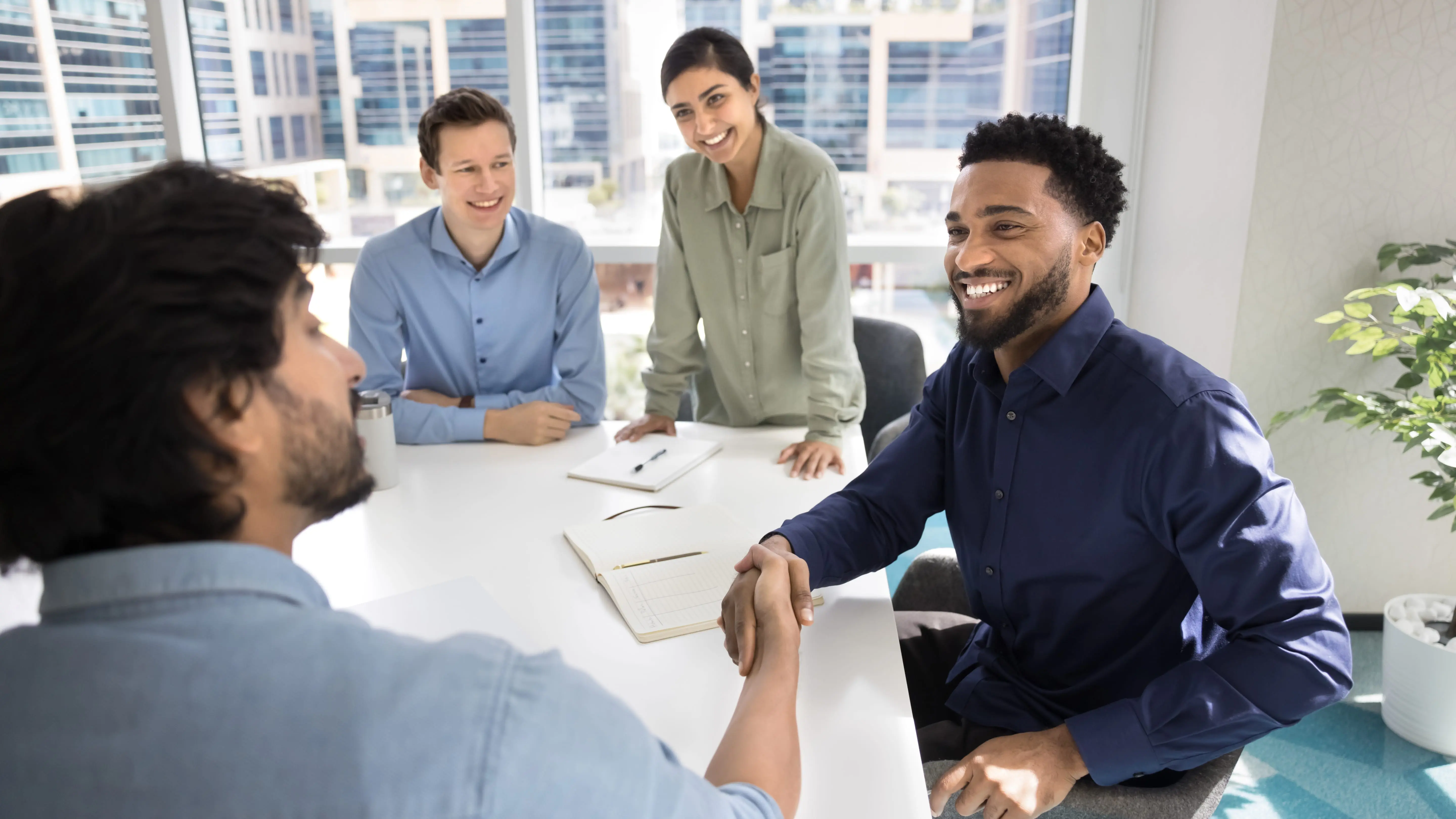 Satisfied stakeholders after successful negotiation at meeting table.